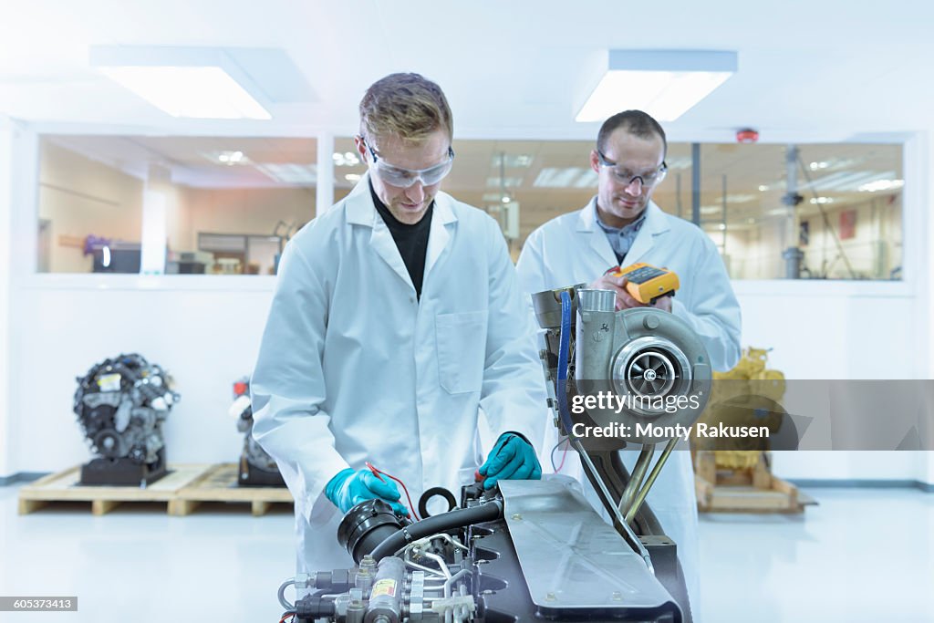 Scientists working in turbo charger automotive research laboratory