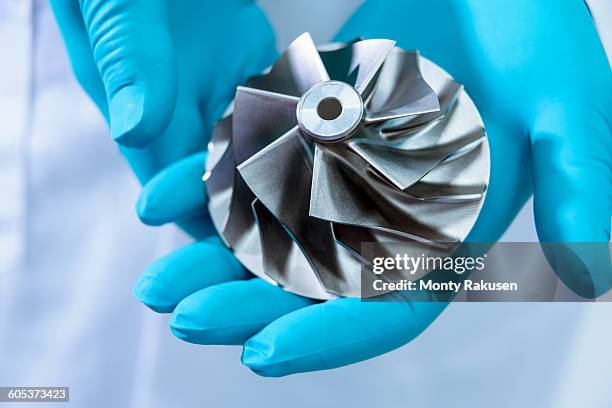 scientist in automotive research laboratory holding turbo charger turbine, close up - car engine close up stock pictures, royalty-free photos & images