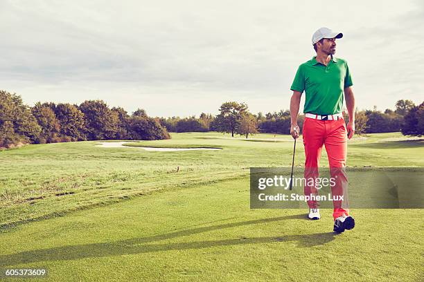 golfer walking on course, korschenbroich, dusseldorf, germany - green pants stock-fotos und bilder