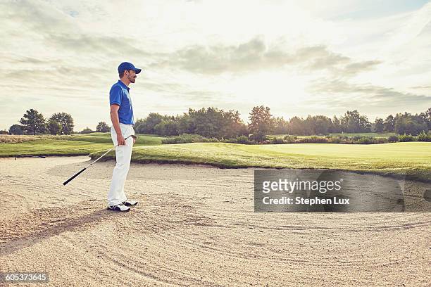 golfer in sand trap, korschenbroich, dusseldorf, germany - golf bunker stock pictures, royalty-free photos & images