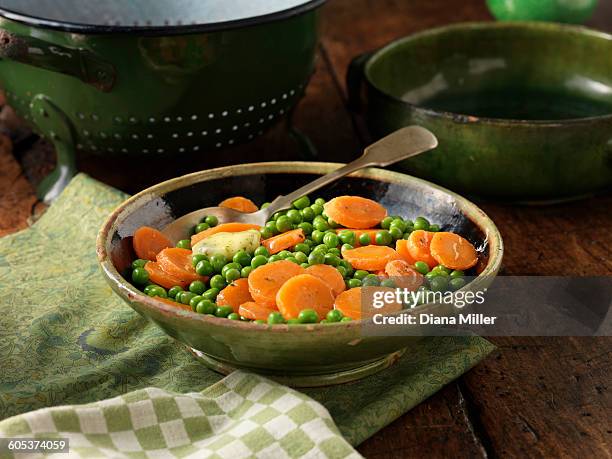 peas and sliced carrots in green serving dish - ceramic green stock pictures, royalty-free photos & images