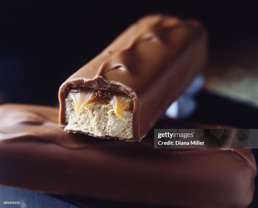Two stacked milk chocolate bars with caramel and nougat filling