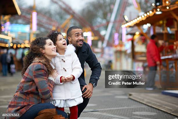 mother and daughter in amusement park looking up smiling - london winter stock pictures, royalty-free photos & images