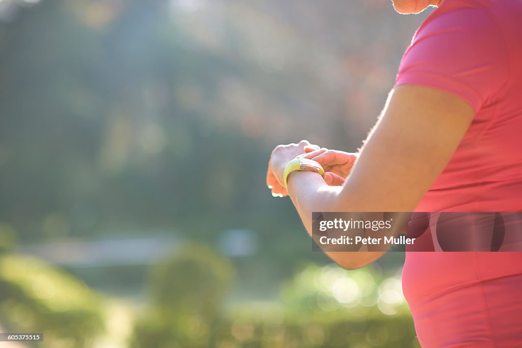 Cropped side view of mature woman checking wrist watch