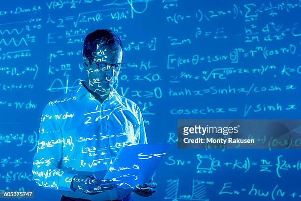scientist with projected mathematical data - mathematician stock pictures, royalty-free photos & images