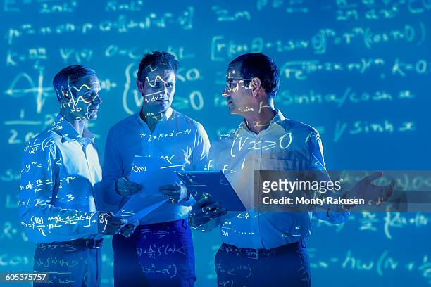 scientists with projected mathematical data - science math stock-fotos und bilder
