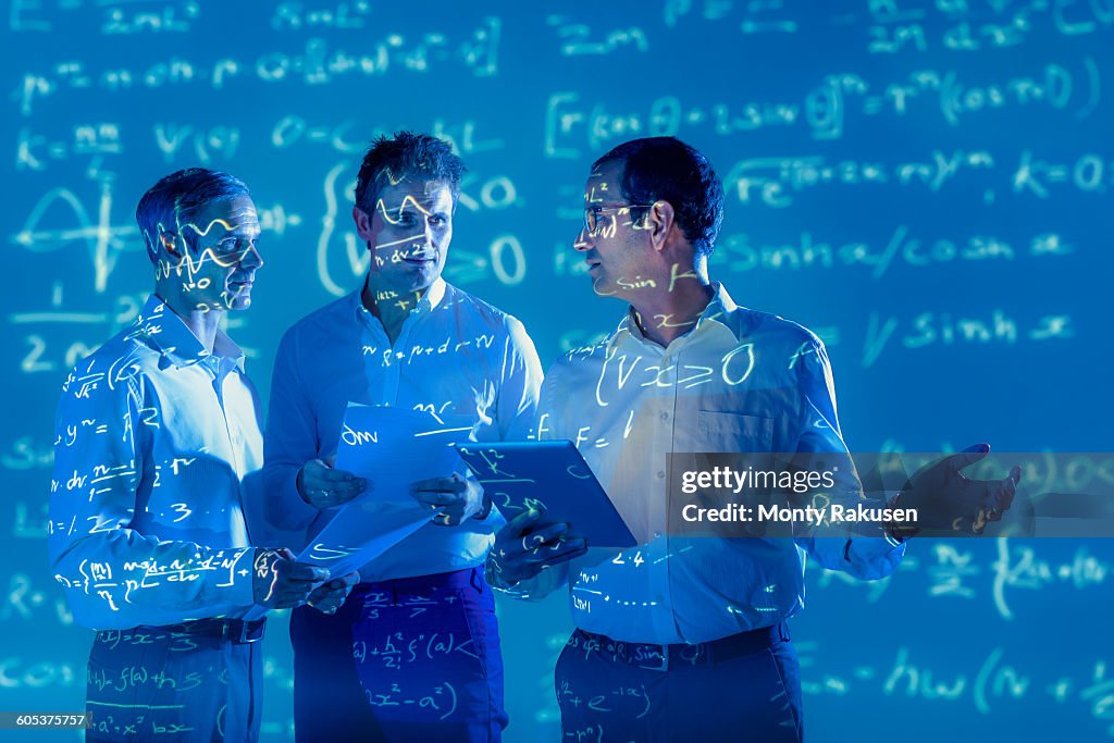 Scientists Using Math Scientists With Projected Mathematical Data High-Res Stock Photo ...