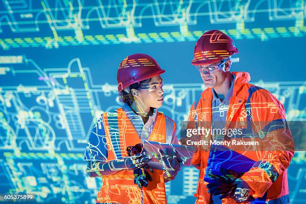 engineers with digital tablet and projected plans - technical skill stock pictures, royalty-free photos & images