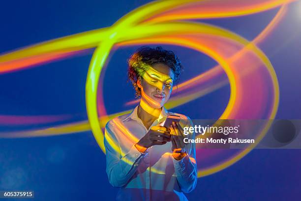 woman using smart phone with projection - multi colored blouse ストックフォトと画像