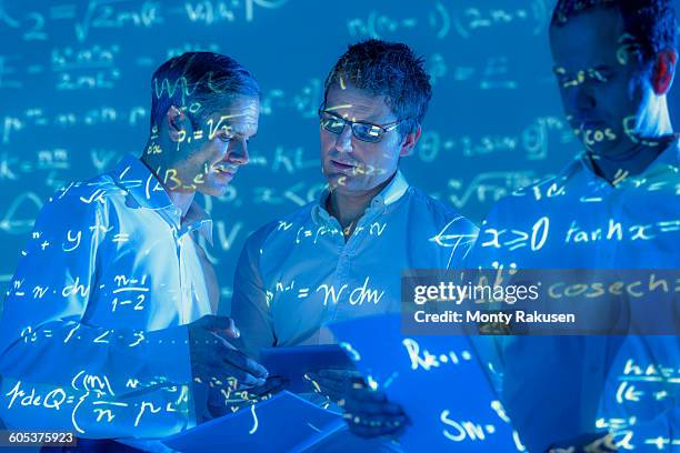 scientists with projected mathematical data - mathematician photos et images de collection