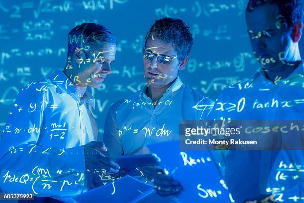scientists with projected mathematical data - mathematician stockfoto's en -beelden