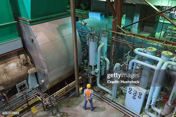 engineer in gas turbine electric power plant exhaust gas and condensation process room - turbina a gas foto e immagini stock