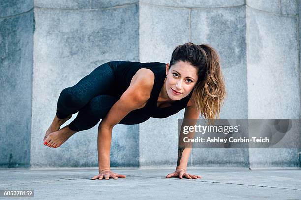 woman in side crow pose (parsva bakasana) - handstand stock pictures, royalty-free photos & images
