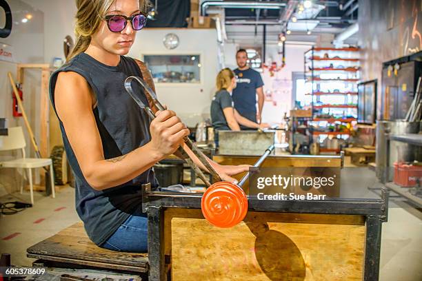 group of young adults blowing glass - glass blowing stockfoto's en -beelden