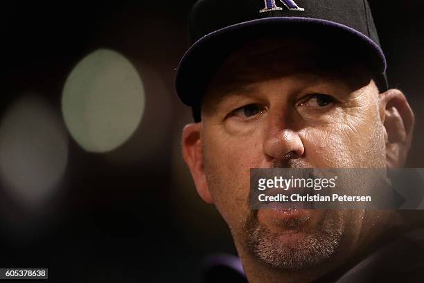 Manager Walt Weiss of the Colorado Rockies watches from the dugout during the MLB game against the Arizona Diamondbacks at Chase Field on September...
