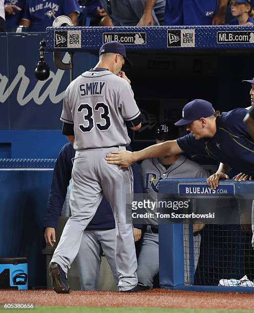 Drew Smyly of the Tampa Bay Rays is congratulated as he exits the game after being relieved in the sixth inning during MLB game action against the...