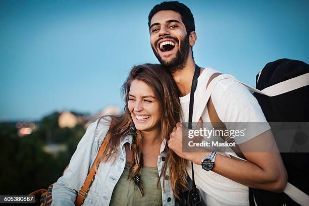 happy tourist couple enjoying against clear blue sky - west asian ethnicity ストックフォトと画像