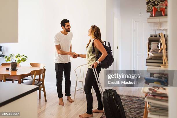 happy man shaking hand with woman going for vacation - sharing economy stock pictures, royalty-free photos & images