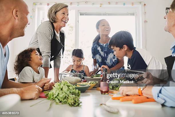 happy multi-ethnic family preparing asian food at kitchen - 3 women senior kitchen stock pictures, royalty-free photos & images