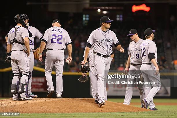 Starting pitcher Jorge De La Rosa of the Colorado Rockies is removed by manager Walt Weiss during the fourth inning of the MLB game against the...