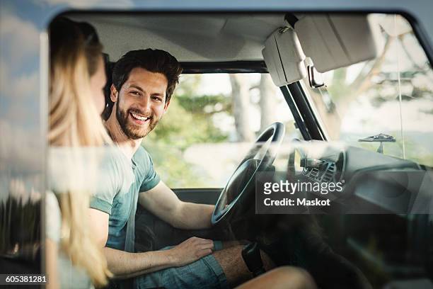 happy man enjoying road trip with woman - two cars ストックフォトと画像