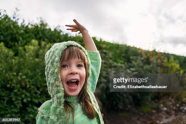 excited girl with raised arm in the rain - waving hand stock pictures, royalty-free photos & images