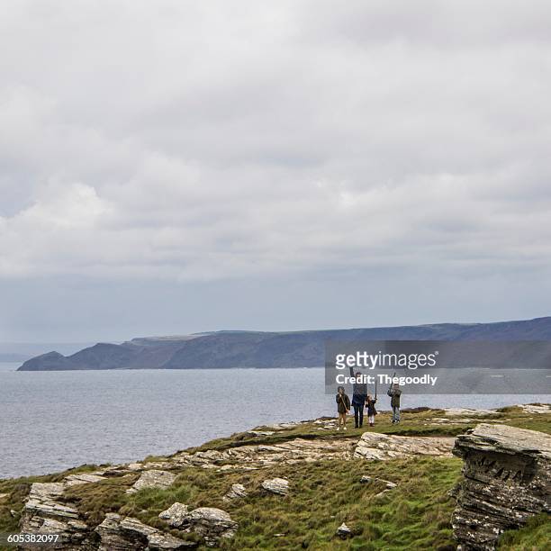 mother with three children waving, tintagel, cornwall, england, uk - person waving stock pictures, royalty-free photos & images