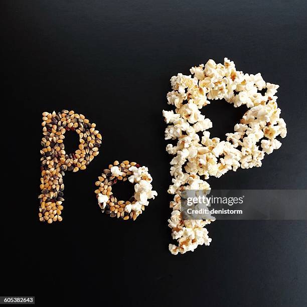 word pop written with popcorn - grain de maïs photos et images de collection