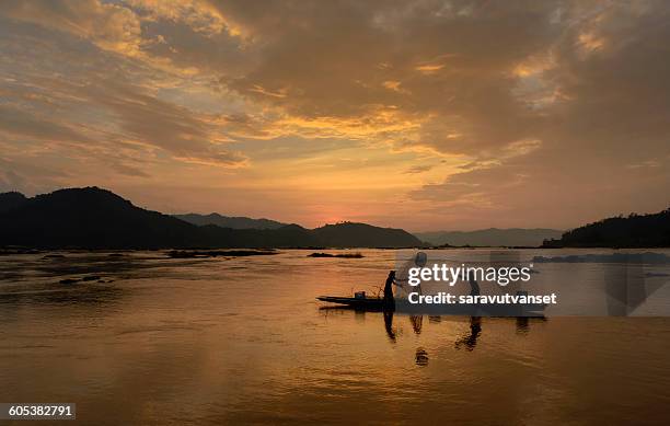 two fishermen fishing, mekong river, sangkhom, thailand - mekong river stock pictures, royalty-free photos & images