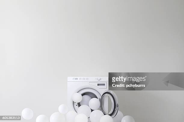 conceptual washing machine leaking soap suds - overflowing fotografías e imágenes de stock