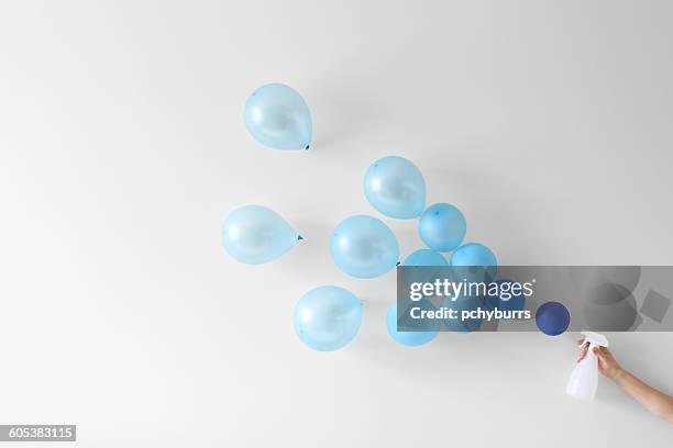 conceptual woman holding a spray bottle spraying water - housework humour stock pictures, royalty-free photos & images