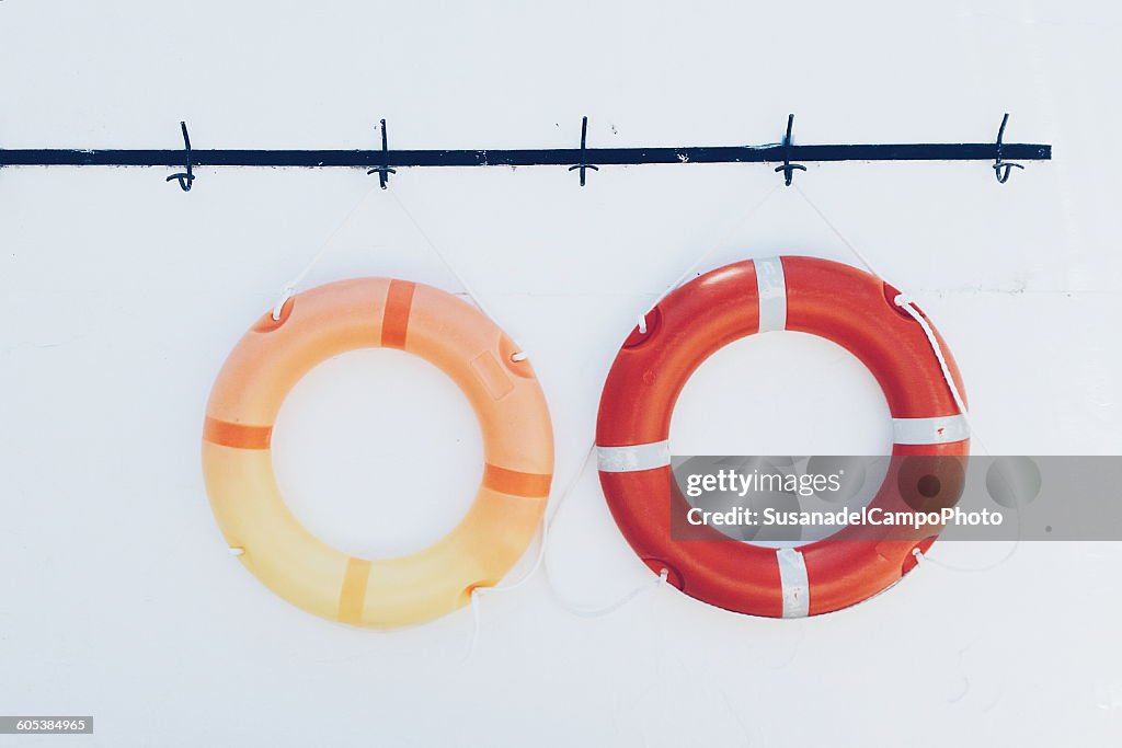 Two lifesavers hanging on a wall