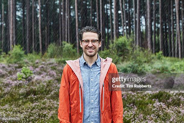 portrait of man in outdoor clothes, bad weather. - orange jacket stock pictures, royalty-free photos & images