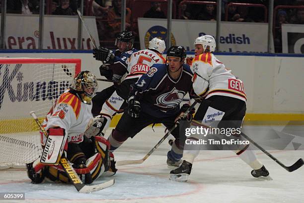 Forward Dan Hinote of the Colorado Avalanche watches as Brynas goaltender Johan Asplund deflects a second period shot during the 2001 NHL Challenge...