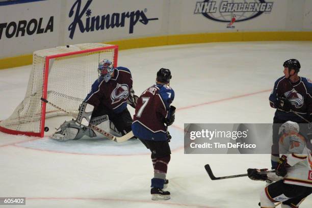 Forward Tom Bissett of Brynas scores his team's second goal of the first period against Patrick Roy of the Colorado Avalanche. Greg de Vries can do...