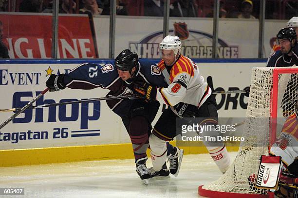 Forward Shjon Podein of the Colorado Avalanche tries to skate through the defense of Henrik Rehnberg of Brynas in the second period of the 2001 NHL...