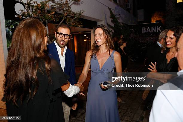 Artist Anne de Carbuccia greets guest at ONE: One Planet One Future at Bank Street Theater on September 13, 2016 in New York City.