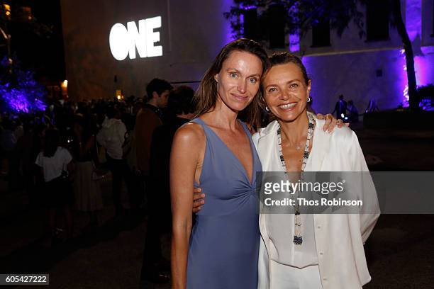 Artist Anne de Carbuccia poses with guest at ONE: One Planet One Future at Bank Street Theater on September 13, 2016 in New York City.