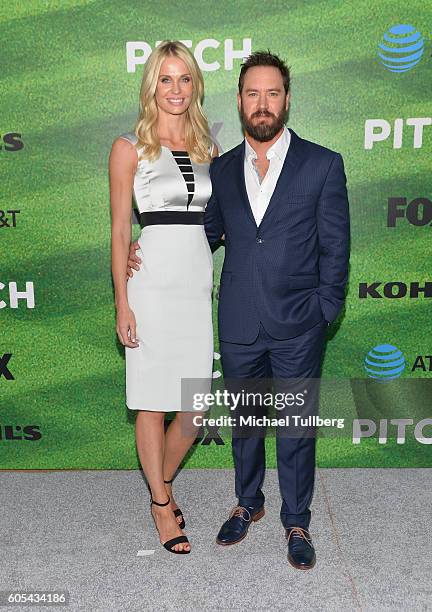 Catriona McGinn and actor Mark-Paul Gosselaar attend the premiere of Fox's "Pitch" at West LA Little League Field on September 13, 2016 in Los...