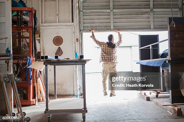 blue collar male working in wood / metal workshop. - open collar fotografías e imágenes de stock