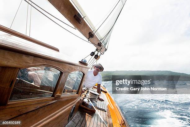skipper at helm of classic yacht - classic day 1 bildbanksfoton och bilder