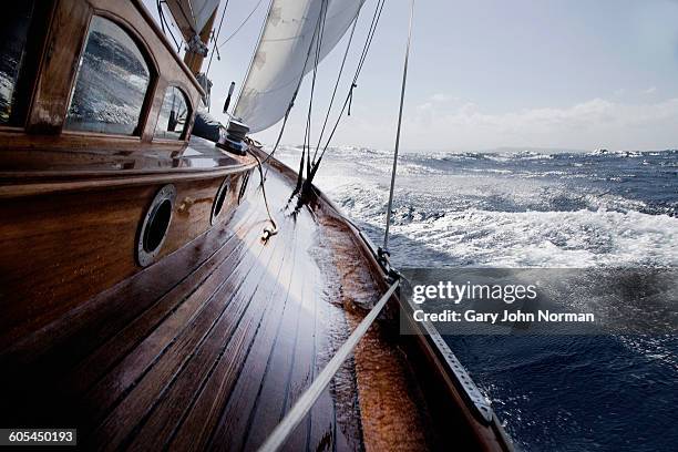 classic yacht with water on the side deck - deck stock-fotos und bilder