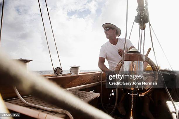 skipper at helm of classic yacht - team captain sport stock pictures, royalty-free photos & images