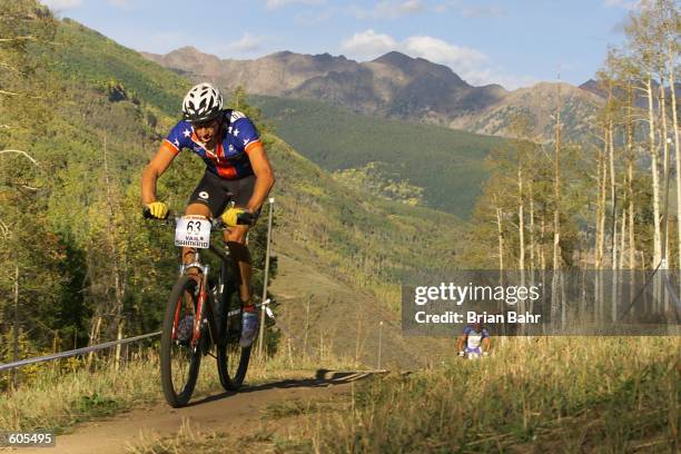 Todd Wells, the top USA men's finisher in 26th place, heads up the mountain with the Gore Range in the background during the cross country...