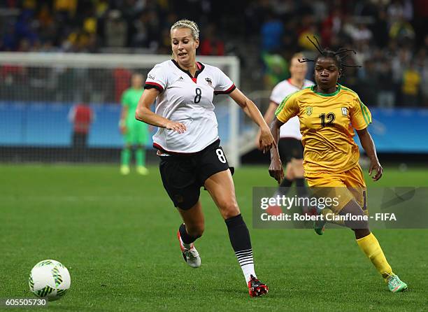 Lena Goessling of Germany is chased by Marjory Nyaumwe of Zimbabwe during the Women's First Round Group F match between Zimbabwe and Germany at Arena...