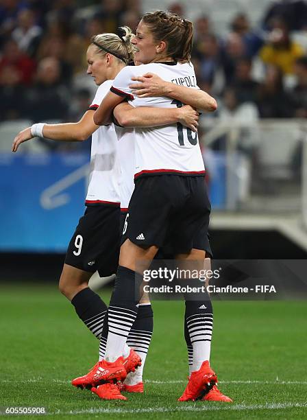 Melanie Leupolz of Germany celebrates with team mates after scoring a goal during the Women's First Round Group F match between Zimbabwe and Germany...