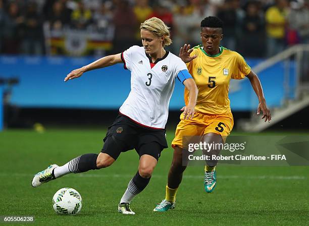 Saskia Bartusiak of Germany is chased by Msipa Emmaculate of Zimbabwe during the Women's First Round Group F match between Zimbabwe and Germany at...