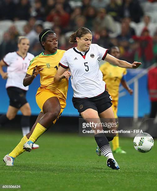 Annike Krahn of Germany is chased by Rutendo Makore of Zimbabwe during the Women's First Round Group F match between Zimbabwe and Germany at Arena...