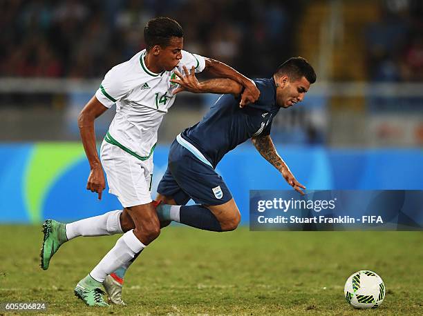 Angel Correa of Argentina is challenged by Sofiiane Bendebka of Algeria during the Olympic Men's Football match between Argentina and Algeria at...