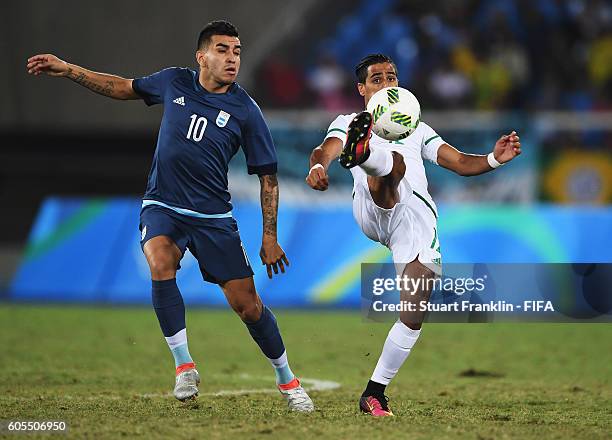 Angel Correa of Argentina is challenged by Abdelraouf Benguit of Algeria during the Olympic Men's Football match between Argentina and Algeria at...